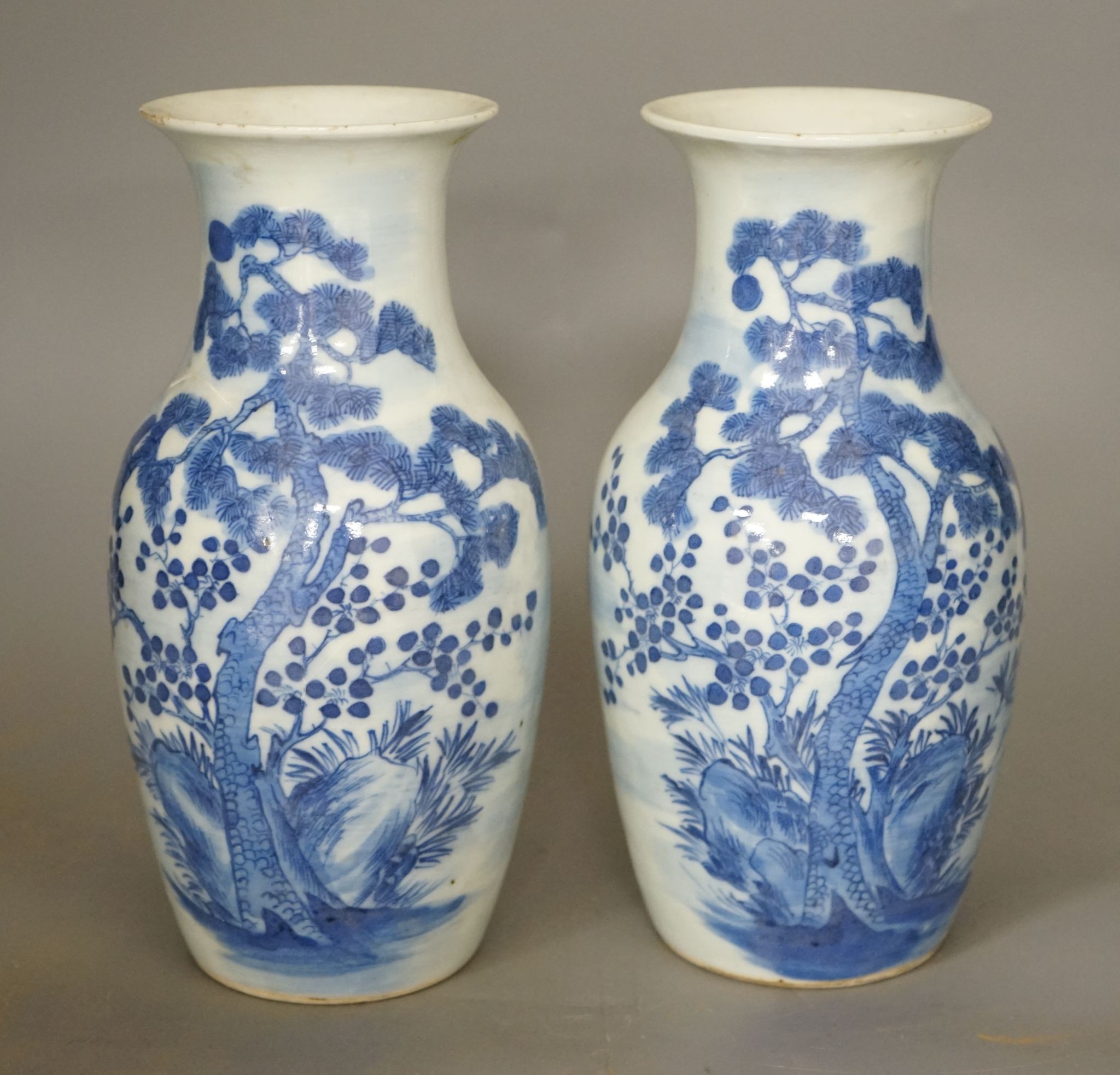 A pair of 19th century Chinese blue and white three friends of winter vases 22cm